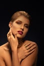 Blonde woman with styled makeÃ¢â¬âup, long necklace and many rings on her fingers Royalty Free Stock Photo